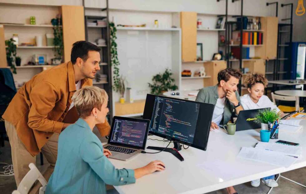 Team collaborating in a modern office, representing managed IT services support and technology management.