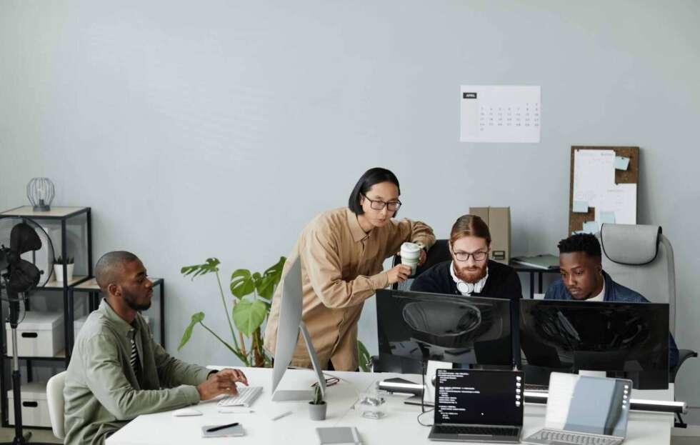 IT professionals collaborating on business technology solutions while evaluating managed IT services cost.